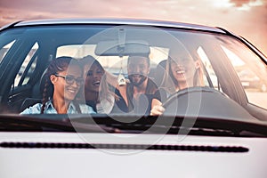 Group of friends having fun in the car photo