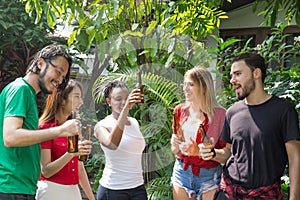 Group of friends having fun and happy in barbecue party at house backyard