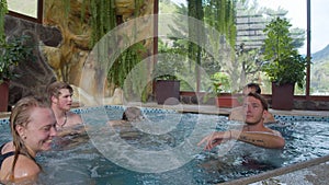 Group of friends having fun on a hot tub