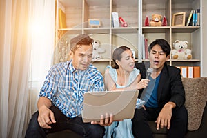 Group of friends having fun at living room singing a song