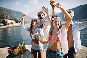 Summer, vacation, party, people concept. Group of friends having fun and party on the beach.