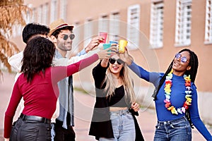 Group of friends having fun while partying together outdoors.