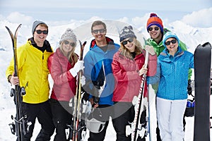 Group Of Friends Having Fun On Ski Holiday In Mountains