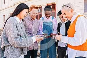 Group of friends having fun with smartphones browsing in social media.