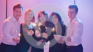 Group of friends having fun with sparklers. Night Party concept