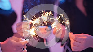 Group of friends having fun with sparklers. Night Party concept