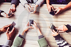 Group of friends having fun together with smart phones - Hands social networking with mobile device - Technology and phone