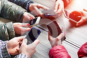 Group of friends having fun together with smartphone - Closeup of hands social networking with mobile smart phone online -