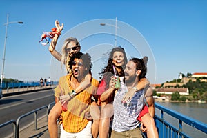 Group of friends having fun, traveling, smiling together outdoors