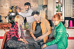 Group of friends having fun using smartphone at hipster bar