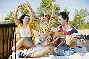 Group of friends having great fun on the beach