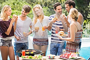 Group of friends having hamburgers and juice