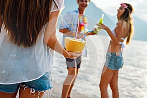 Group of friends having Hawaiian party on summer vacation. People fun travel concept.