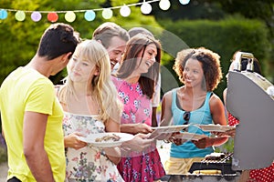 Group Of Friends Having Outdoor Barbeque At Home