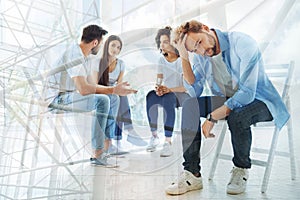 Group of friends having a talk with psychologist