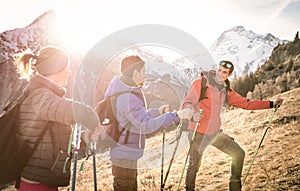 Group of friends hikers trekking on french alps at sunset