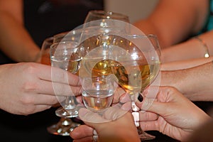 Group of friends hit â€“ clink Champagne glasses to ring in the New Year and Christmas