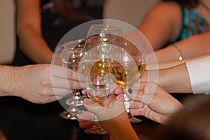 Group of friends hit â€“ clink Champagne glasses to ring in the New Year and Christmas