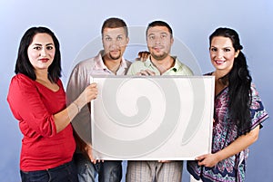 Group of friends hold a blank banner