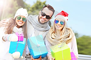 Group of friends holding Christmas presents