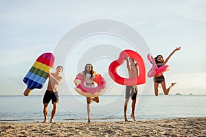 Group friends jumping enjoy life playing and freedom beach at sunset, Attractive together