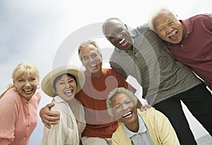 Group of friends laughing outdoors (low angle view)