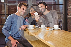 Group of friends looking at their smartphone