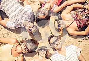 Group of friends lying on the beach