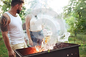 Group of friends making barbecue in the backyard. concept about good and positive mood with friends