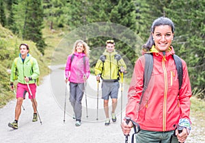 Group of friends making trekking excursion in the forest