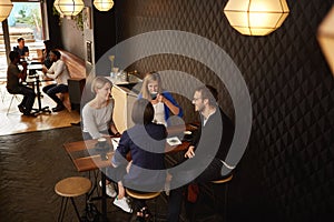 Group of friends meeting for cappucinos in a coffee shop