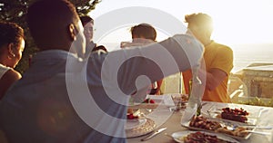 Group, friends and outdoor dinner at sunset and drinks, food and wine for people together for rooftop meal in nature