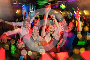 Group of friends partying in a nightclub