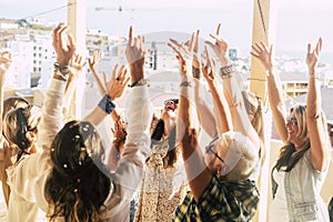 Group of friends people young and aged women celebrate together with confetti in outdoor with city view - concept of friendship