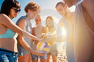 Group of friends that play beachvolley having fun on the beach