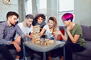 A group of friends play board games in the room.