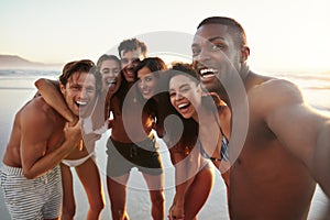 Group Of Friends Posing For Selfie Together On Beach Vacation