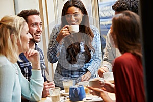 Group Of Friends Relaxing In Cafï¿½ Together