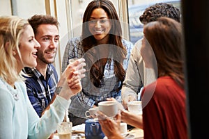 Group Of Friends Relaxing In Cafï¿½ Together