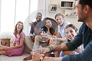 Group Of Friends Relaxing At Home And Drinking Wine Together