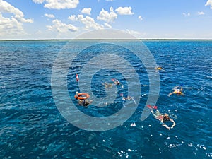 Group of friends relaxing together on a party boat tour of the Carribean Sea