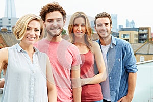 Group Of Friends Relaxing Together On Rooftop Terr