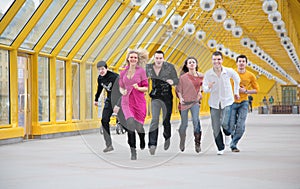 Group of friends runs on yellow footbridge