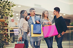 Group Of Friends Shopping In Mall Together