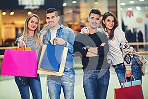 Group Of Friends Shopping In Mall Together