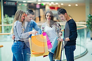 Group Of Friends Shopping In Mall Together