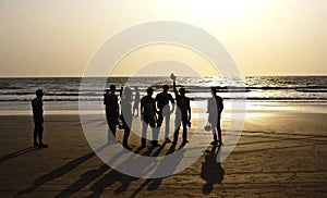 A group of friends silhouetted at Arambol Beach, North Goa