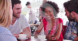 Group Of Friends Sitting In Coffee Shop Chatting