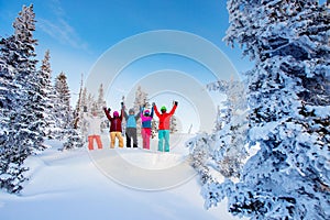 Group friends with ski and snowboard on winter holidays. Skiers having fun on forest snow Sunrise blue sky on top of