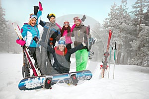 Group of friends skiers and snowboarders having fun on snowbound photo